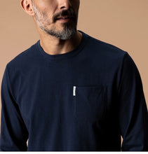 Load image into Gallery viewer, Man wearing a long-sleeve crew neck pullover with a small chest pocket and brand label
