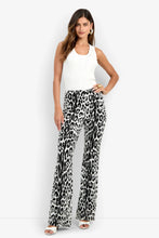 Load image into Gallery viewer, Model wearing wide-leg snow leopard print pants paired with a sleeveless ribbed top