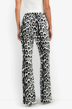 Load image into Gallery viewer, Woman wearing wide-leg flared trousers featuring bold leopard print pattern, back view