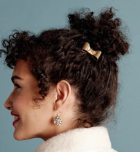 Load image into Gallery viewer, Woman wearing elegant crystal drop earrings with curly updo hair and gold bow clip