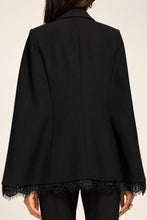 Load image into Gallery viewer, Black structured cape blazer with floral lace trim hem, back view
