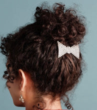 Load image into Gallery viewer, Crystal bow hairclip securing a curly updo, adorned with sparkling rhinestone embellishments