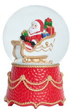 Load image into Gallery viewer, Red and gold snow globe with Santa Claus in sleigh filled with colorful gifts