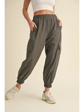 Load image into Gallery viewer, Women wearing relaxed fit cargo jogger pants with elastic waistband and ankle cuffs