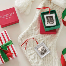 Load image into Gallery viewer, Mariposa Signature Photo Ornament displayed in gift box alongside Christmas stocking and wrapped presents