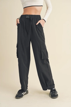 Load image into Gallery viewer, Wide-leg nylon cargo pants with belt buckle waist, multiple pockets, and cuffed hem