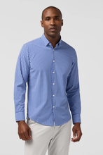 Load image into Gallery viewer, Man wearing a long-sleeve button-down gingham check shirt with light chino pants