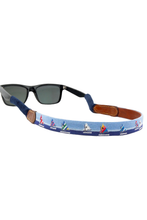 Load image into Gallery viewer, Needlepoint sunglass strap featuring sailboat motifs attached to classic wayfarers