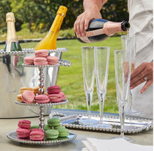 Load image into Gallery viewer, Mariposa Beaded Medium Tray displayed outdoors holding champagne flutes at an elegant garden party