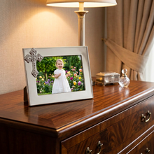 Load image into Gallery viewer, Mariposa Cross Frame displayed on dresser holding a smiling child's photo in garden setting