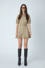 Load image into Gallery viewer, Olive suede mini dress with belted waist, puff sleeves, and flared hem styled with black boots