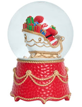 Load image into Gallery viewer, Red and gold Christmas snow globe with Santa Claus in sleigh full of gifts