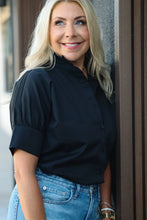 Load image into Gallery viewer, Black short sleeve button-front shirt with ruffle collar, worn with blue jeans