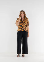 Load image into Gallery viewer, Woman wearing Emily McCarthy Poppy Top Leopard with wide-leg trousers and heeled mules