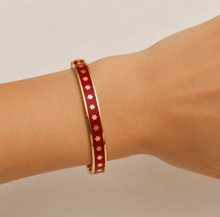 Load image into Gallery viewer, Halcyon Days Skinny Star Hinged Bangle featuring enamel finish with gold star motifs, worn on wrist
