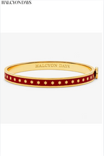 Load image into Gallery viewer, Gold and red enamel hinged bangle bracelet with star pattern by Halcyon Days