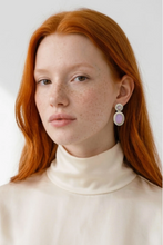 Load image into Gallery viewer, Model wearing elegant double oval drop earrings with stone details, showcasing Tat2 Forte style
