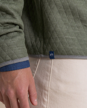 Load image into Gallery viewer, Green quilted pullover with blue brand tag and gray trim detail