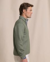 Load image into Gallery viewer, Man wearing sage green quilted quarter-snap pullover over blue collared shirt