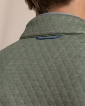 Load image into Gallery viewer, Close-up of olive green quilted jacket back with blue loop detail