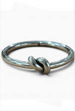 Load image into Gallery viewer, Tat2 Vintage Noa Knot Bangle featuring a sleek metallic finish with an elegant knot detail