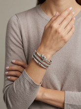 Load image into Gallery viewer, Model wearing stacked Tat2 Vintage Silver Noa Knot Bangle with chain and twisted bangles on wrist