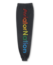 Load image into Gallery viewer, Kids cozy fleece sweatpants with bold multicolor Aviator Nation logo down the leg