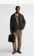 Load image into Gallery viewer, Barbour Field Wax Laptop Bag in black, carried by male model in wax jacket