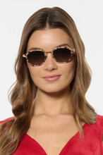 Load image into Gallery viewer, Woman wearing Krewe Dakota polarized geometric sunglasses with tortoise acetate frames and gold hardware