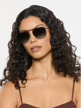 Load image into Gallery viewer, Woman wearing Krewe Zander Fold aviator sunglasses with metal frame and gradient lenses