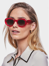 Load image into Gallery viewer, Woman wearing bold oval acetate sunglasses with gradient lenses and gold hoop earrings