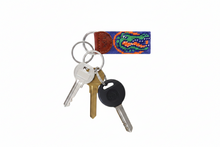 Load image into Gallery viewer, A Florida Gators themed woven keychain featuring a blue canvas strap with the green and orange alligator logo, a brown leather tab stamped with 'S&amp;L E', and two silver metal key rings.
