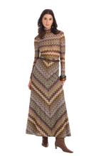 Load image into Gallery viewer, Model wearing a long chevron patterned knit skirt with matching turtleneck top and belt