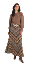 Load image into Gallery viewer, Woman wearing a long chevron patterned maxi skirt with a knit sweater and boots