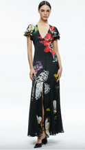 Load image into Gallery viewer, This Alice + Olivia dress is a showstopper. It is a maxi length dress that features a v-neckline that is button down the front. It is a black background with vibrant flowers and butterflies. Sleeves are flowy.