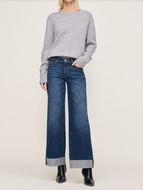 Women's wide leg cuffed dark blue jeans with gold hardware and black ankle boots