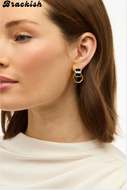 Gold hoop earrings with black and white rectangular stud top worn by woman