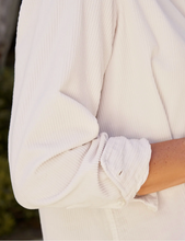 Load image into Gallery viewer, Close-up of rolled cuff detail on a textured corduroy button-up shirt