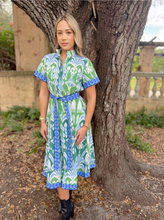 Load image into Gallery viewer, Woman wearing a printed midi shirtdress with belt and short sleeves, styled with boots