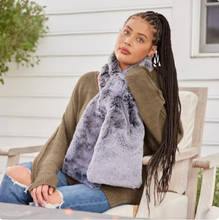 Load image into Gallery viewer, Woman sitting outdoors wearing a luxurious faux fur scarf with a cozy sweater and jeans