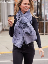 Load image into Gallery viewer, Woman walking outdoors wearing a luxurious faux fur scarf with a coffee cup