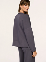 Load image into Gallery viewer, Woman wearing a relaxed-fit open-front cardigan with long sleeves and clean seam detailing