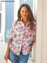 Load image into Gallery viewer, Woman wearing a floral button-up shirt with long sleeves, paired with jeans