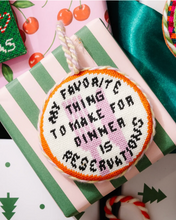 Load image into Gallery viewer, Needlepoint Christmas ornament reading 'My Favorite Thing To Make For Dinner Is Reservations'
