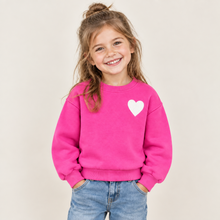 Load image into Gallery viewer, Smiling girl wearing a heart graphic crewneck sweatshirt paired with denim jeans