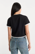 Load image into Gallery viewer, Woman wearing a cropped short sleeve ringer tee with contrast trim detailing, paired with denim jeans, shown from the back
