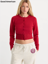 Load image into Gallery viewer, Woman wearing a cropped button-front fine knit cardigan with long sleeves and ribbed hem