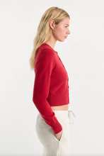 Load image into Gallery viewer, Woman wearing a cropped fine knit cardigan with long sleeves and button front closure