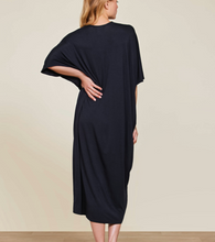 Load image into Gallery viewer, Woman wearing a flowing midi-length caftan dress with batwing sleeves, shown from behind