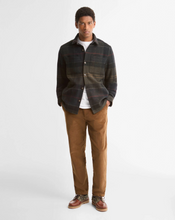 Load image into Gallery viewer, Man wearing a plaid wool overshirt layered over a white tee with chinos and boat shoes